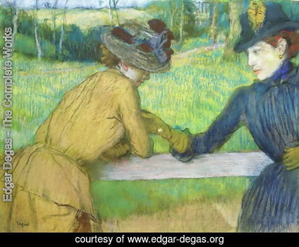 Two women leaning on a gate